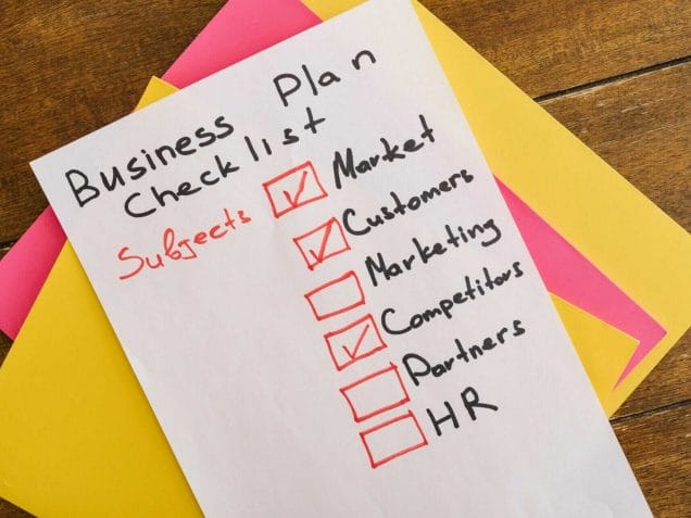 a business plan checklist written on paper